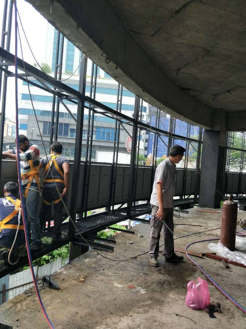 Installation team fitting LED display steel framework