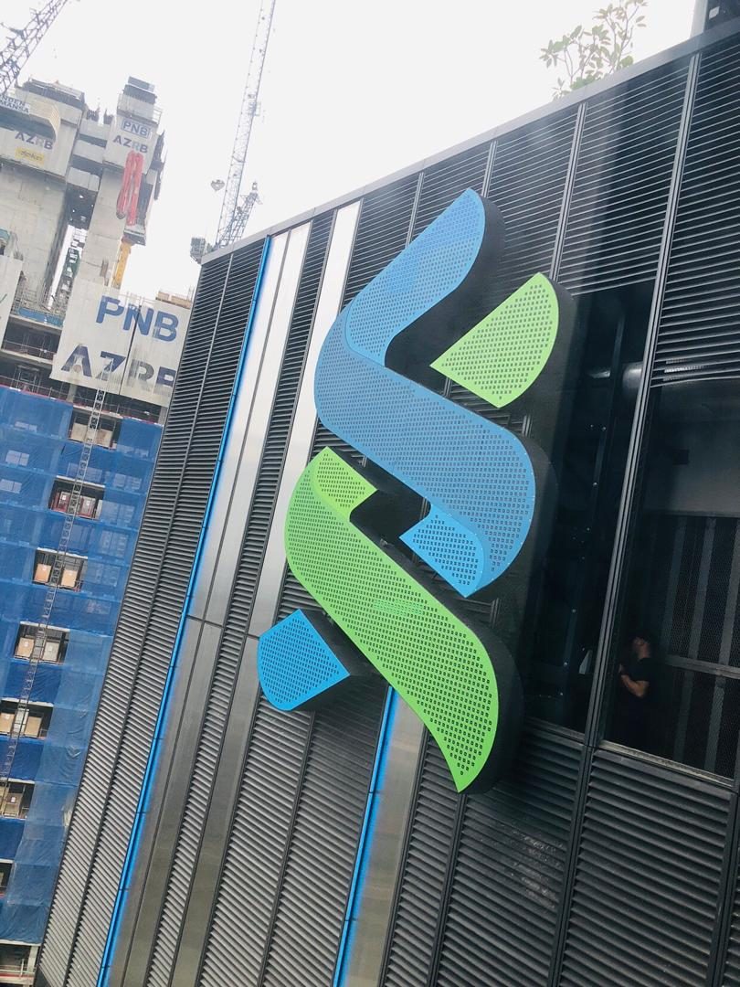 Standard Chartered logo installed on a louvred building façade