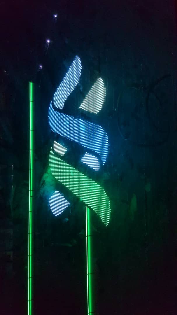 Illuminated corporate façade signage at night